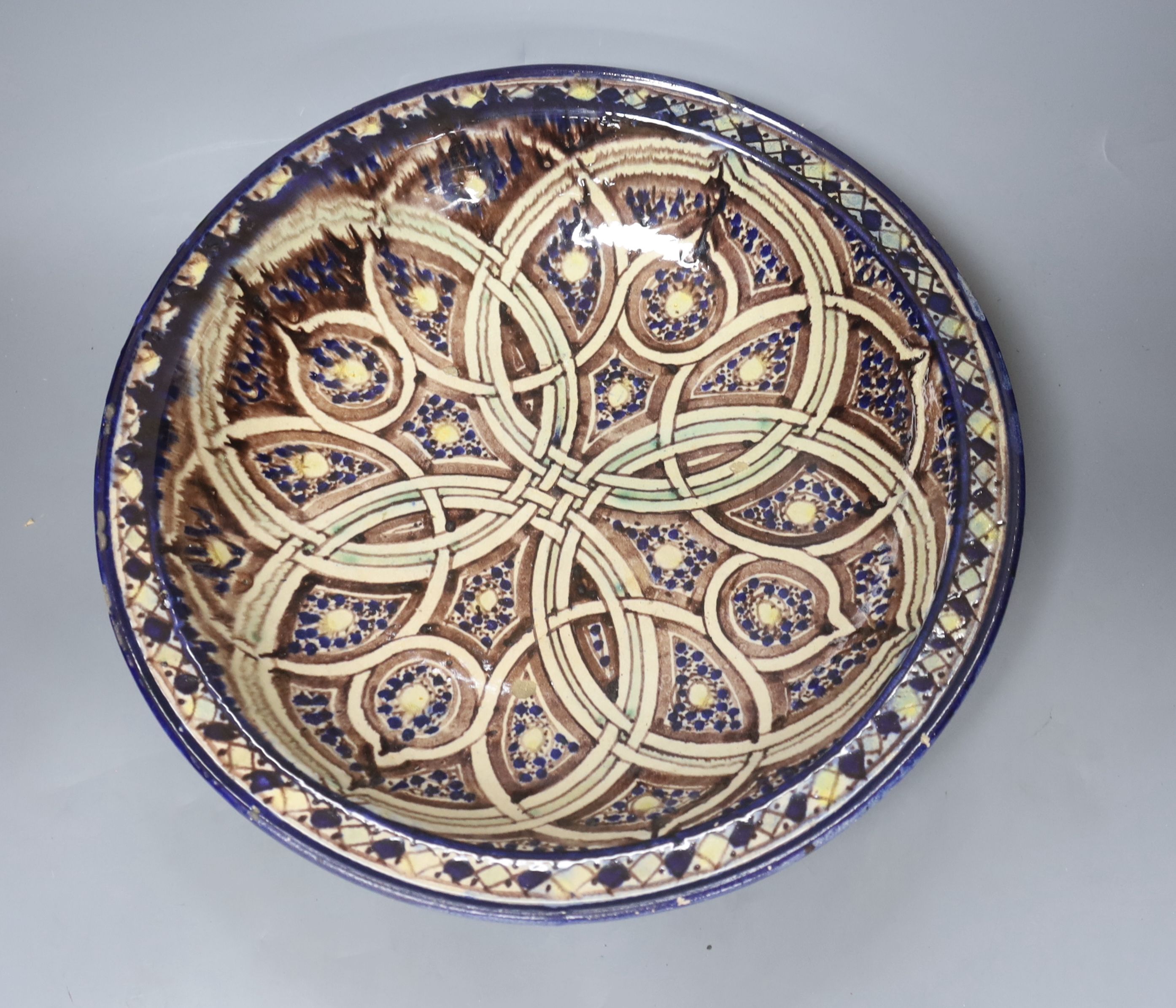 A Moroccan pottery dish, diameter 36cm, and three fritware animal figures